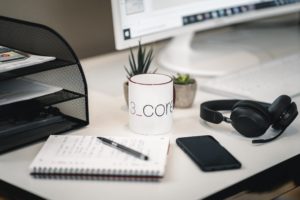 Authorities crisis management exercise 3 A tidy desk with a notebook, a pen, a smartphone, a white coffee mug, wireless headphones, two small potted plants, a monitor, and a black file organizer—perfect for you and your partner to stay organized and inspired.